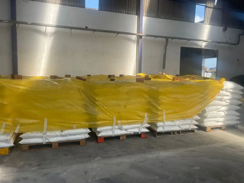 Palletized refined sugar bags in warehouse