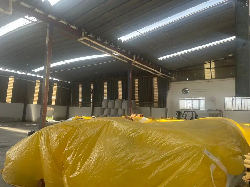 Covered pallets of bagged sugar in a controlled warehouse